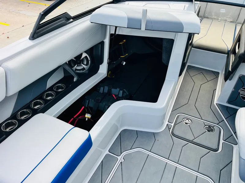Slide: The Image of Interior of 2020 Malibu Wakesetter 24 MXZ boat with seating and storage compartments. - 22