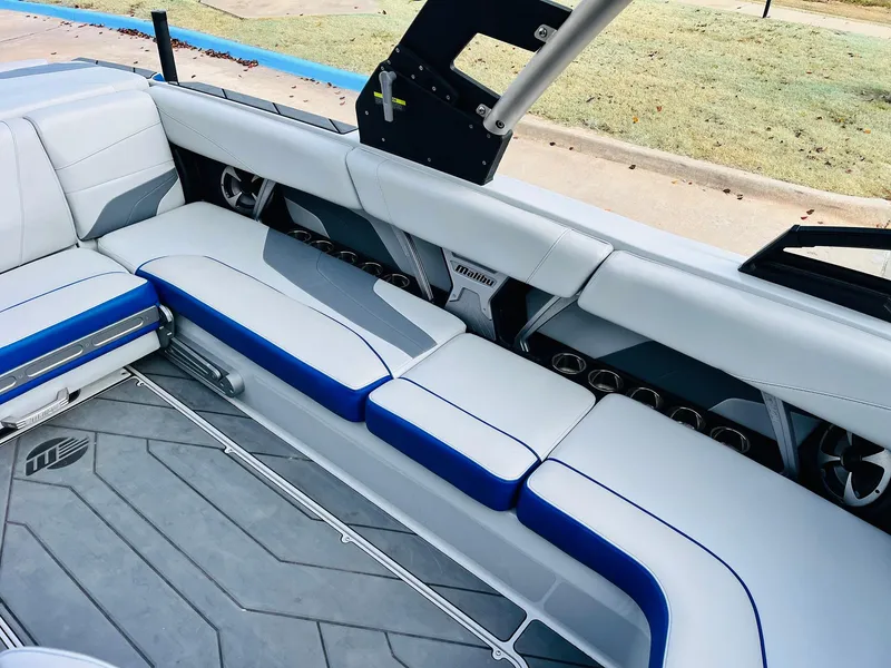 Slide: The Image of 2020 Malibu Wakesetter 24 MXZ interior with sleek white and blue seating. - 23
