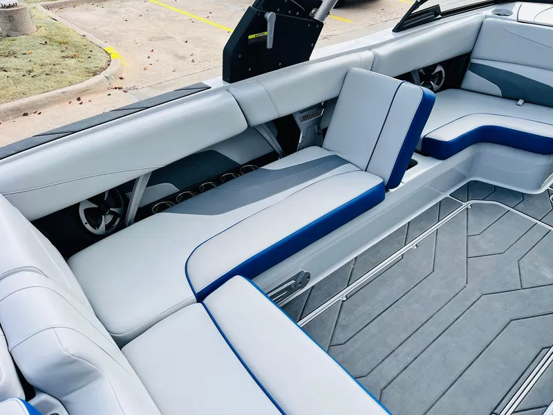 Slide: The Image of 2020 Malibu Wakesetter 24 MXZ interior with sleek gray and blue seating. - 25
