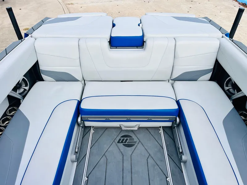 Slide: The Image of 2020 Malibu Wakesetter 24 MXZ interior with white and blue seating. - 28