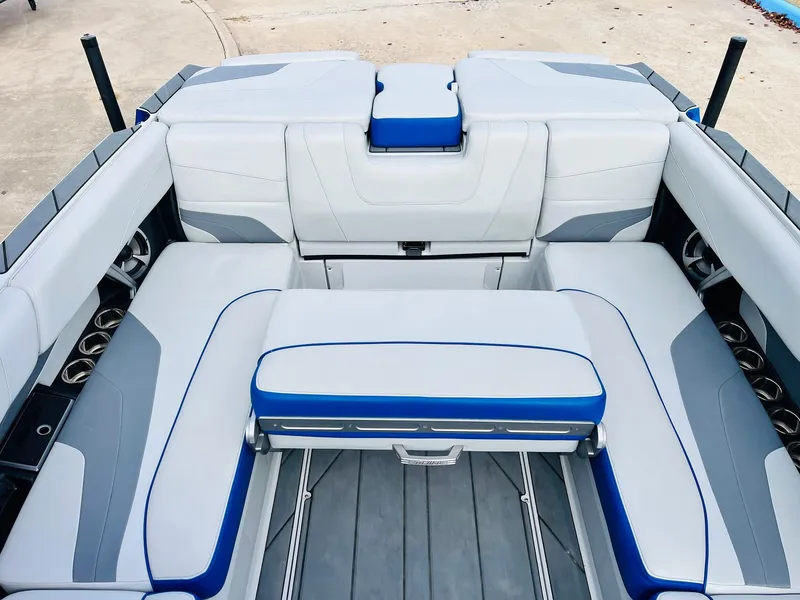 Slide: The Image of 2020 Malibu Wakesetter 24 MXZ boat interior with gray and blue seating. - 29