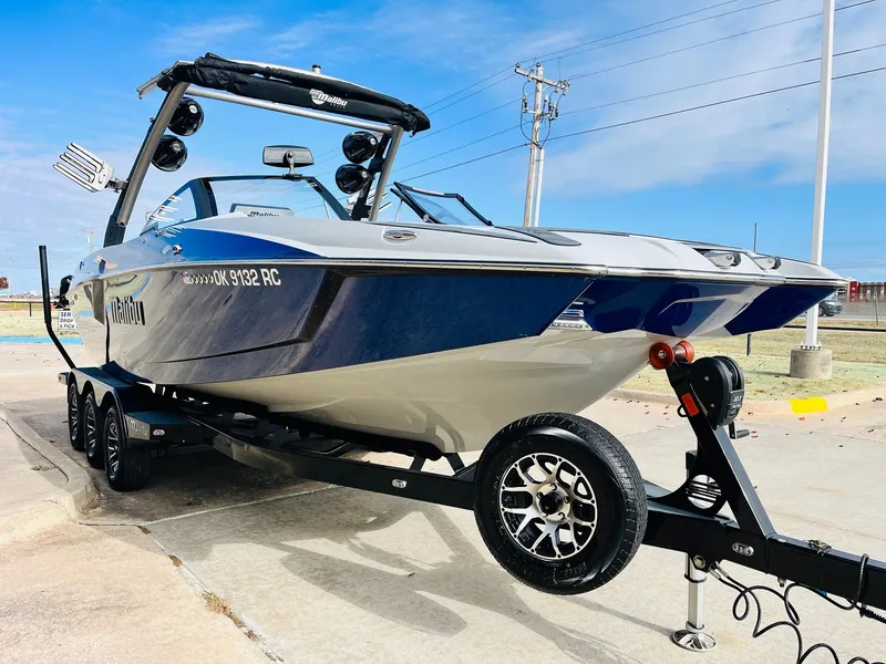Slide: The Image of 2020 Malibu Wakesetter 24 MXZ boat on trailer, parked outdoors. - 3