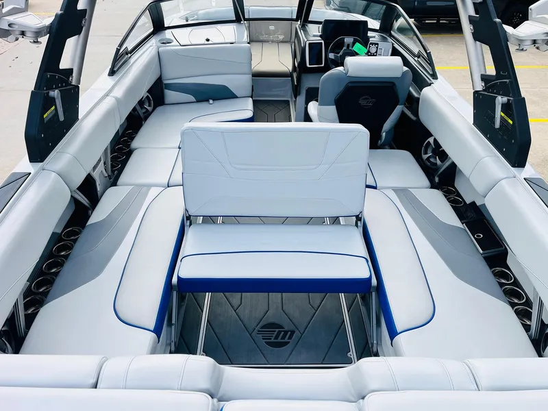 Slide: The Image of 2020 Malibu Wakesetter 24 MXZ interior with luxurious seating and modern dashboard. - 31