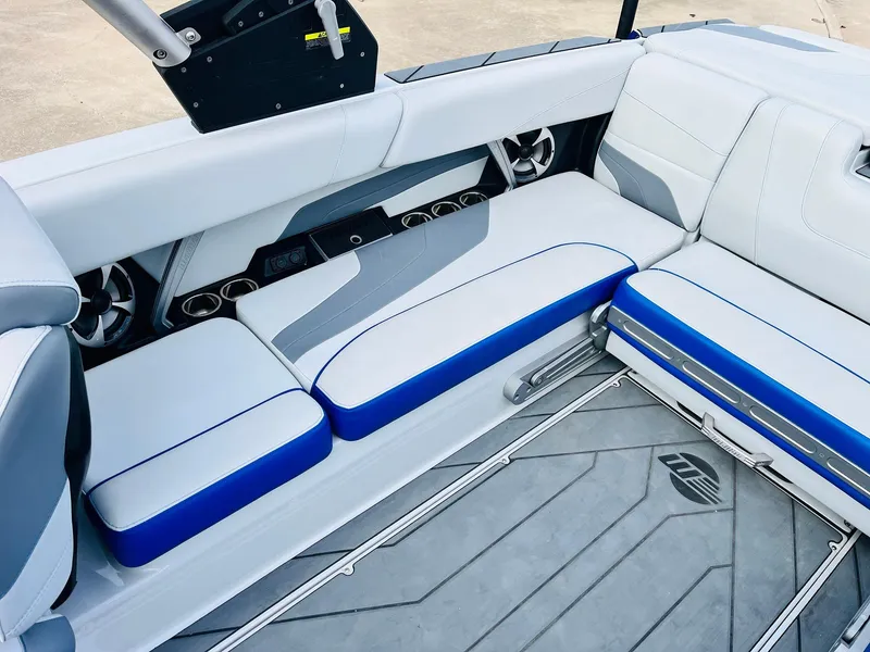 Slide: The Image of 2020 Malibu Wakesetter 24 MXZ interior with blue and white seating. - 32