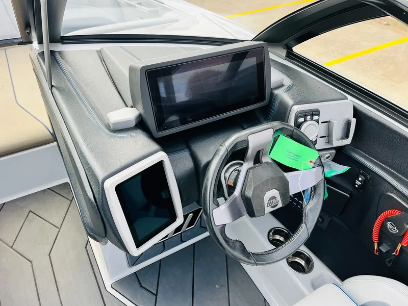 Slide: The Image of 2020 Malibu Wakesetter 24 MXZ dashboard with modern controls and steering wheel. - 42