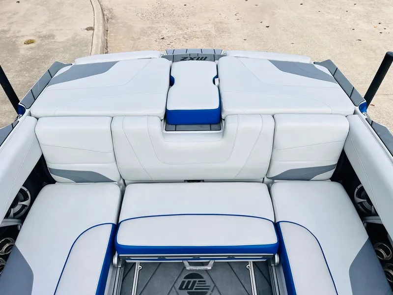 Slide: The Image of 2020 Malibu Wakesetter 24 MXZ boat interior with sleek gray and blue seating. - 43