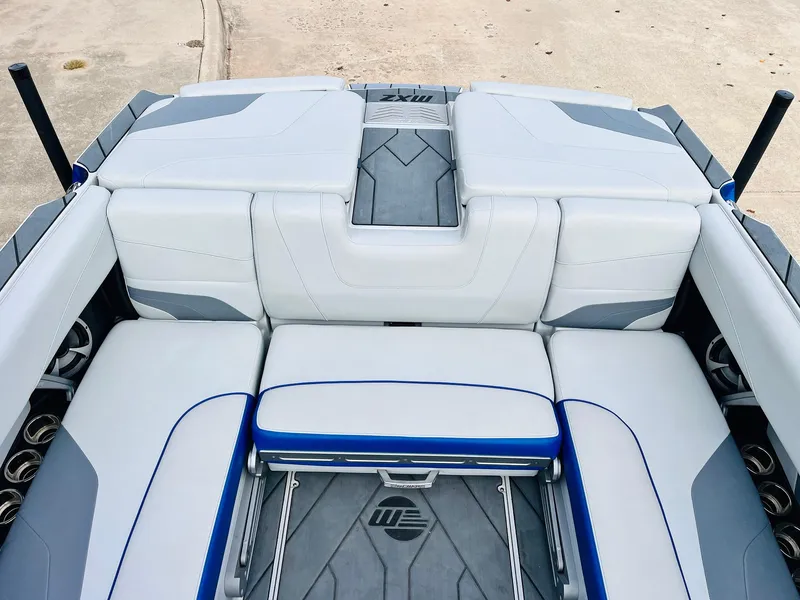 Slide: The Image of 2020 Malibu Wakesetter 24 MXZ boat interior with white and gray seating. - 44