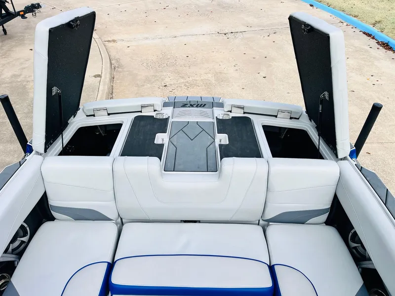 Slide: The Image of 2020 Malibu Wakesetter 24 MXZ boat interior with open storage compartments. - 45