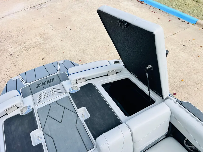 Slide: The Image of 2020 Malibu Wakesetter 24 MXZ boat with open storage compartment on deck. - 46