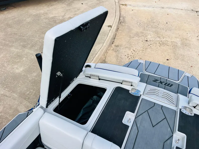 Slide: The Image of 2020 Malibu Wakesetter 24 MXZ boat with open storage compartment. - 47