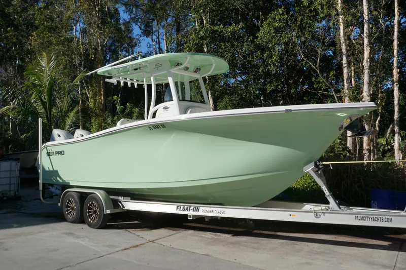 Slide: The Image of 2021 Sea Pro 259 Center Console boat on trailer, parked outdoors. - 1
