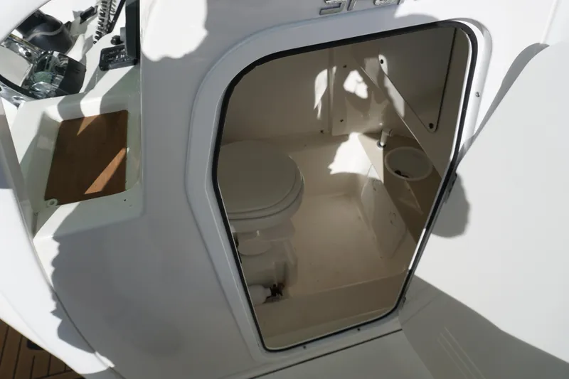 Slide: The Image of 2021 Sea Pro 259 Center Console boat interior with compact marine toilet. - 10