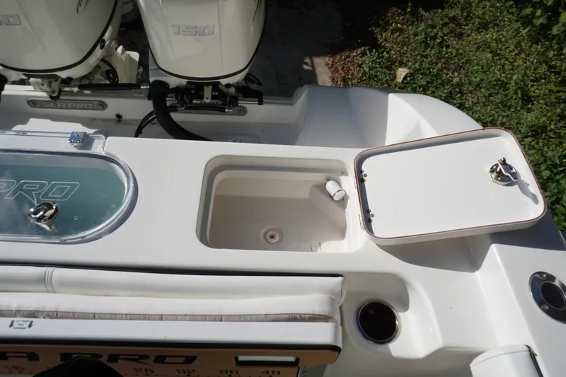 Slide: The Image of 2021 Sea Pro 259 Center Console boat deck with storage compartments and dual engines. - 16