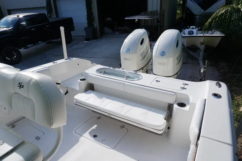 Slide: The Image of 2021 Sea Pro 259 Center Console boat with dual Suzuki engines, docked outdoors. - 17