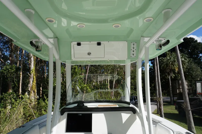 Slide: The Image of 2021 Sea Pro 259 Center Console boat interior with green canopy and control panel. - 4