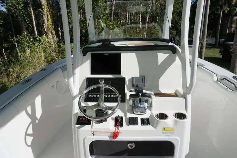 Slide: The Image of 2021 Sea Pro 259 Center Console boat interior with steering wheel and controls. - 5