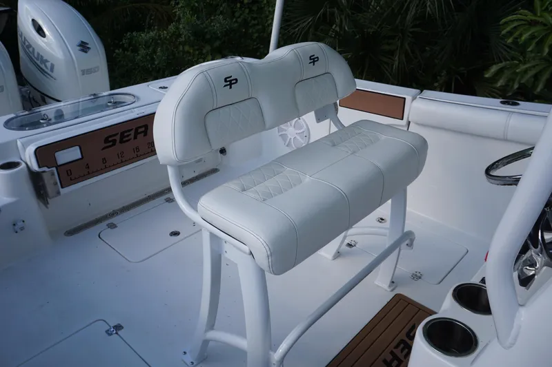 Slide: The Image of 2021 Sea Pro 259 Center Console boat interior with white seating and console details. - 8