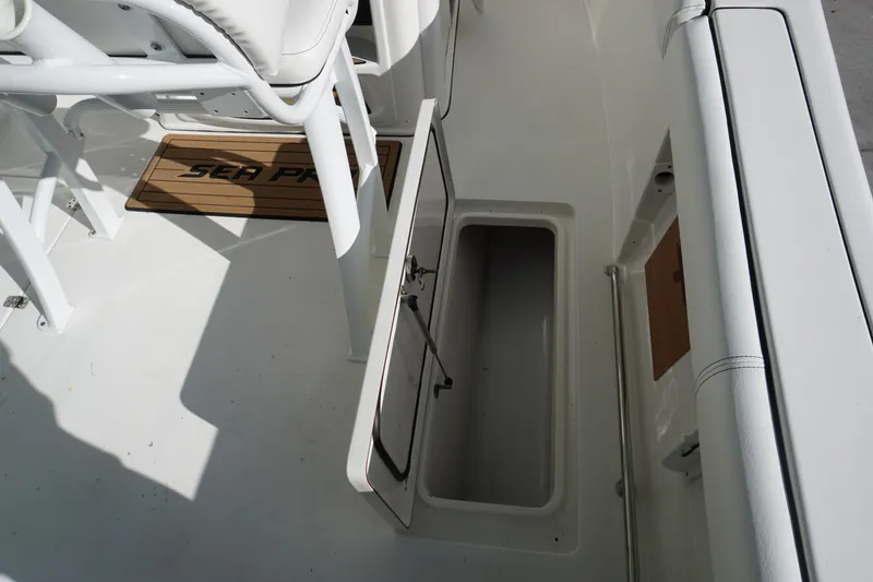 Slide: The Image of 2021 Sea Pro 259 Center Console boat interior with open storage compartment. - 9