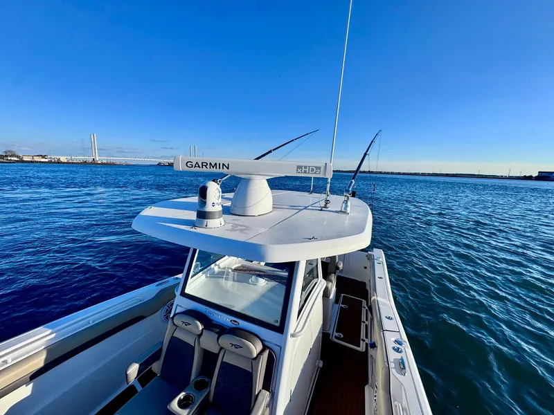 Slide: The Image of 2021 Tidewater 320 CC Adventure boat on open water, featuring Garmin radar. - 21