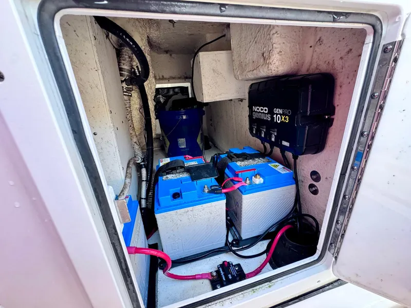 Slide: The Image of 2021 Tidewater 320 CC Adventure boat battery compartment with NOCO Genius charger. - 24