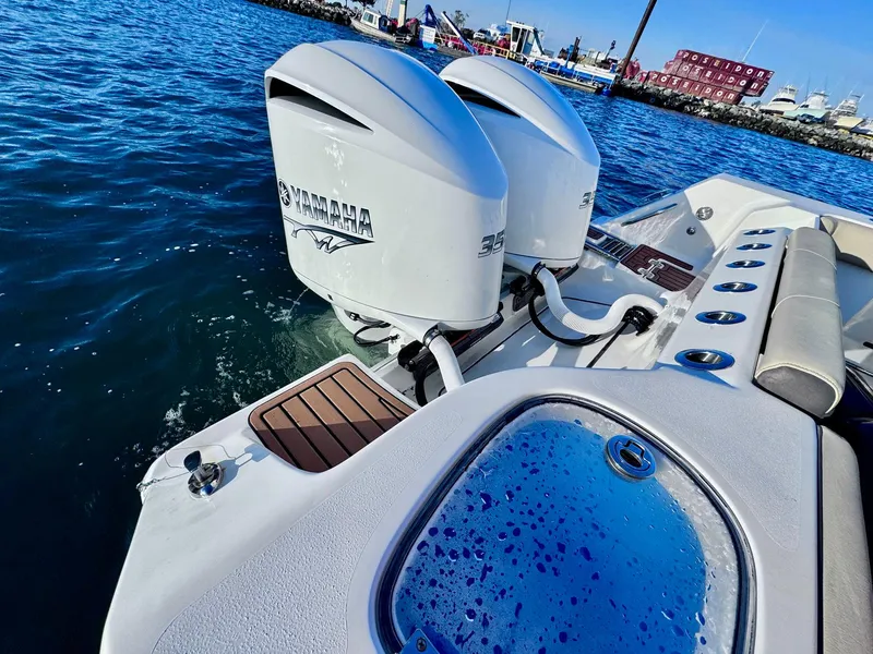 Slide: The Image of Tidewater 320 CC Adventure 2021 with dual Yamaha outboard engines on the water. - 4