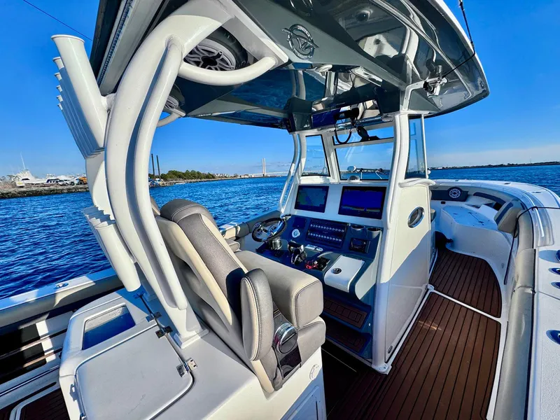 Slide: The Image of 2021 Tidewater 320 CC Adventure boat cockpit with modern controls and ocean view. - 9