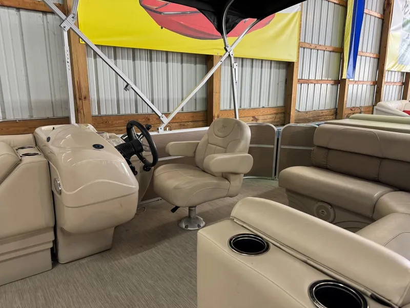 Slide: The Image of 2018 Misty Harbor 2085 Adventure CR pontoon boat interior with beige seating and steering console. - 5