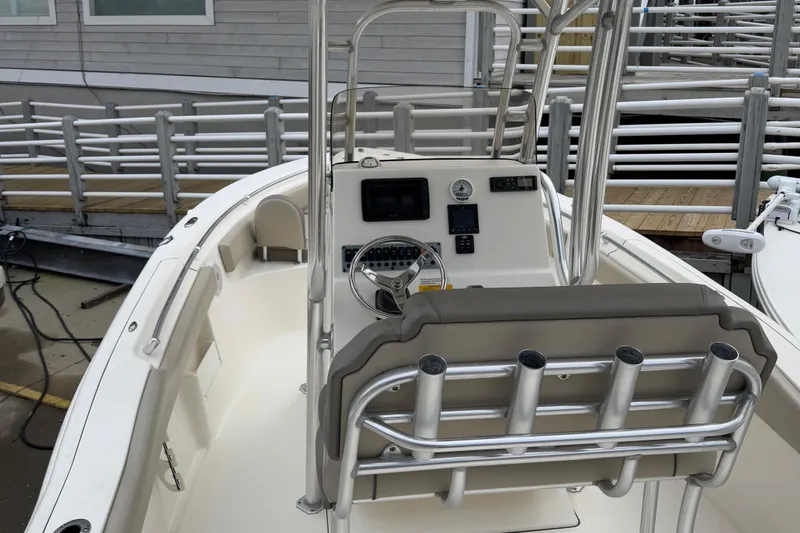 Slide: The Image of 2021 Key West 239 FS boat interior with steering console and rod holders. - 4