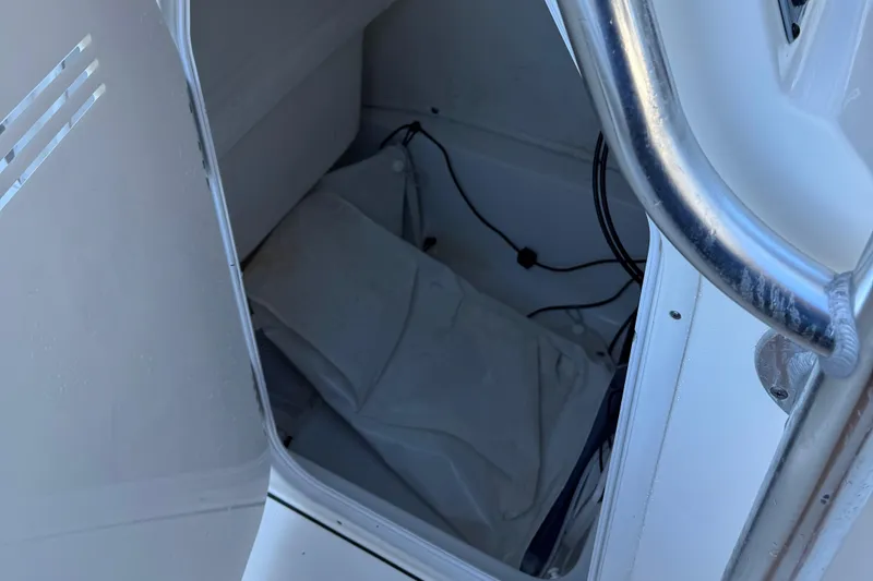 Slide: The Image of 2021 Key West 239 FS boat storage compartment with wiring and cover. - 8
