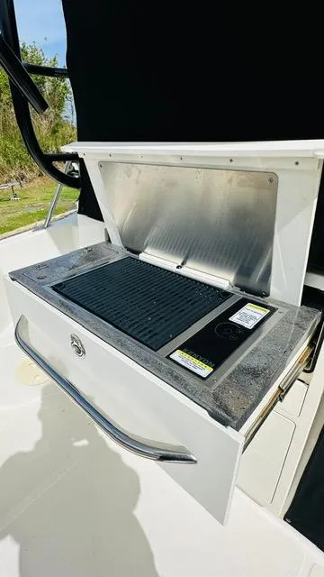Slide: The Image of 2023 Boston Whaler 325 boat grill station with stainless steel cover. - 8