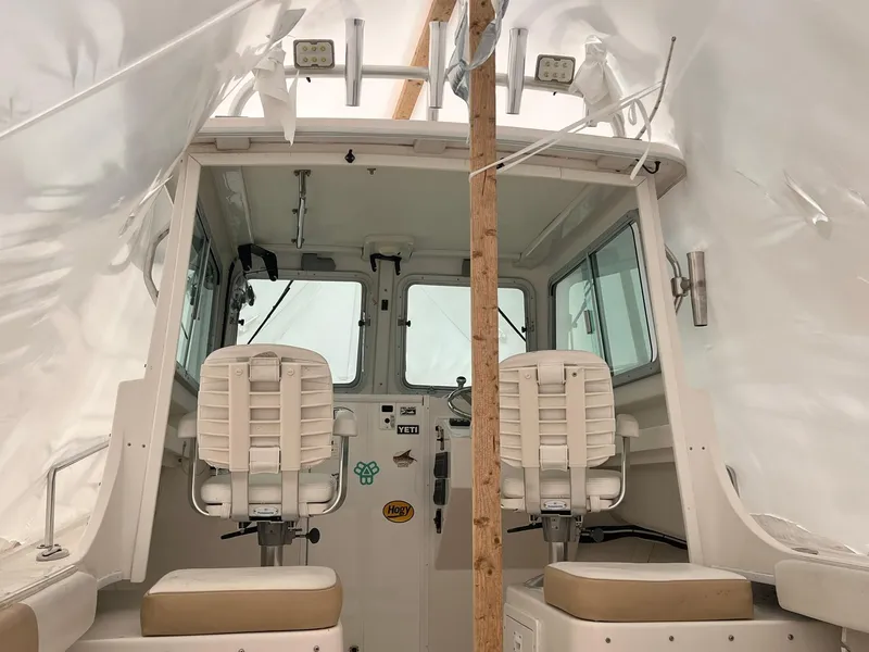 Slide: The Image of 2016 Steiger Craft 23 Miami boat interior with two seats under protective cover. - 15