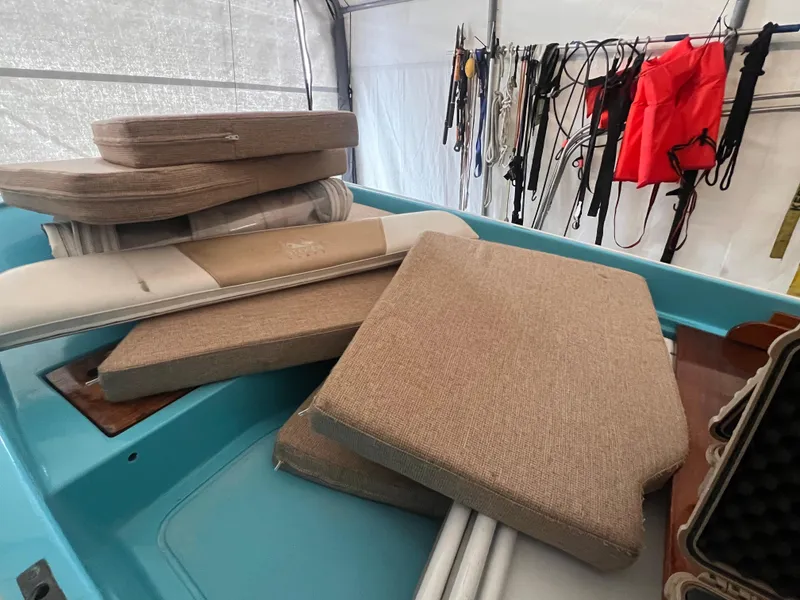 Slide: The Image of Cushions stacked on a 2016 Steiger Craft 23 Miami boat in a storage area. - 21