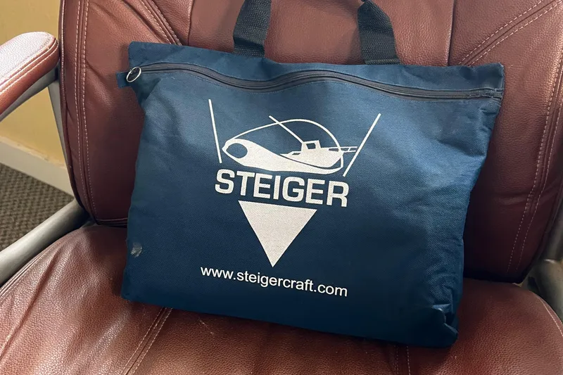 Slide: The Image of Blue Steiger Craft bag on brown chair, featuring logo and website. - 28