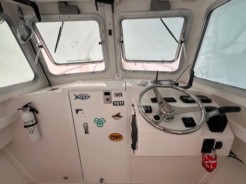 Slide: The Image of Steiger Craft 23 Miami 2016 boat cockpit with steering wheel and control panel. - 29