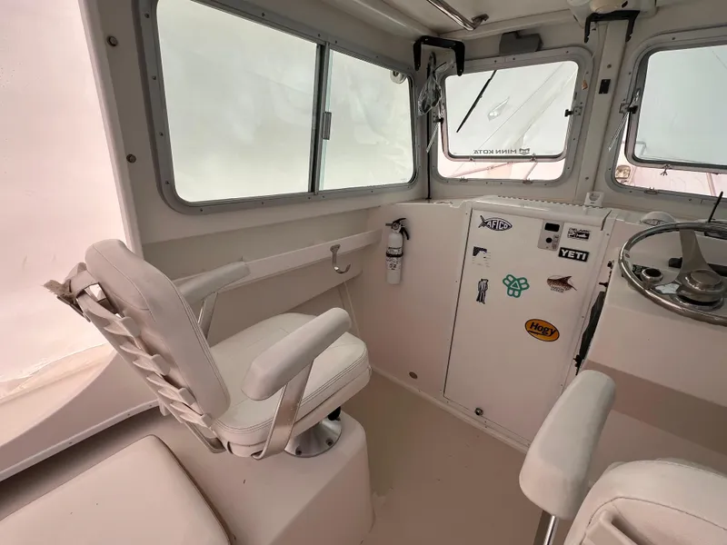 Slide: The Image of 2016 Steiger Craft 23 Miami boat interior with helm and seating area. - 30