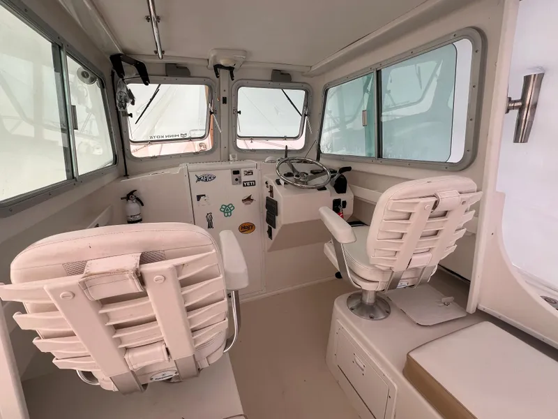 Slide: The Image of 2016 Steiger Craft 23 Miami boat interior with helm and seating. - 31