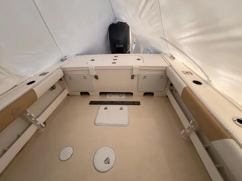 Slide: The Image of 2016 Steiger Craft 23 Miami boat interior with storage compartments and engine. - 32