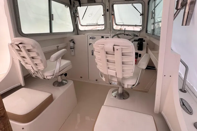 Slide: The Image of 2016 Steiger Craft 23 Miami boat interior with helm and seating. - 33