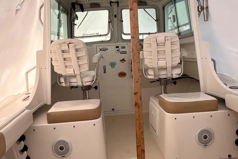 Slide: The Image of 2016 Steiger Craft 23 Miami boat interior with two white captain chairs. - 34