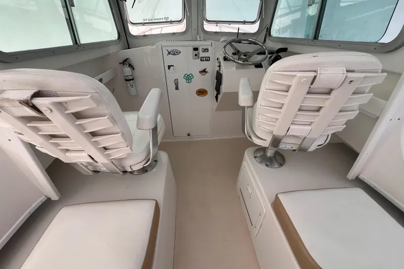 Slide: The Image of 2016 Steiger Craft 23 Miami boat interior with white seating and steering console. - 35