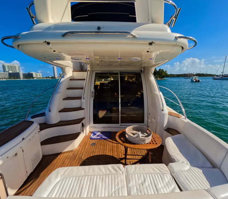 Slide: The Image of Luxury 2004 Sealine 47 yacht with spacious deck and scenic ocean view. - 11