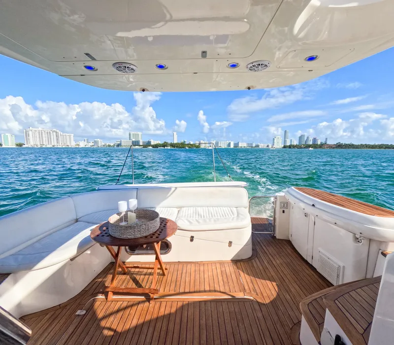 Slide: The Image of Luxury Sealine 47 yacht deck with ocean view, featuring comfortable seating and table, 2004 model. - 12