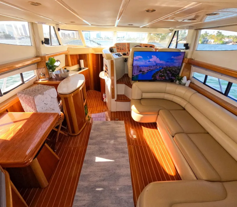 Slide: The Image of Luxurious interior of a 2004 Sealine 47 yacht with leather seating and wooden accents. - 13