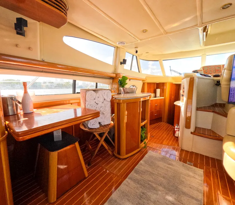 Slide: The Image of Luxurious interior of 2004 Sealine 47 yacht with wooden furnishings and ample natural light. - 16