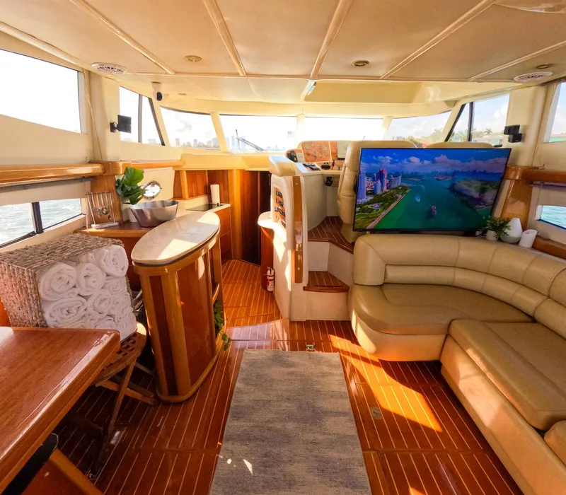 Slide: The Image of Luxurious 2004 Sealine 47 yacht interior with leather seating, wood accents, and large TV. - 18