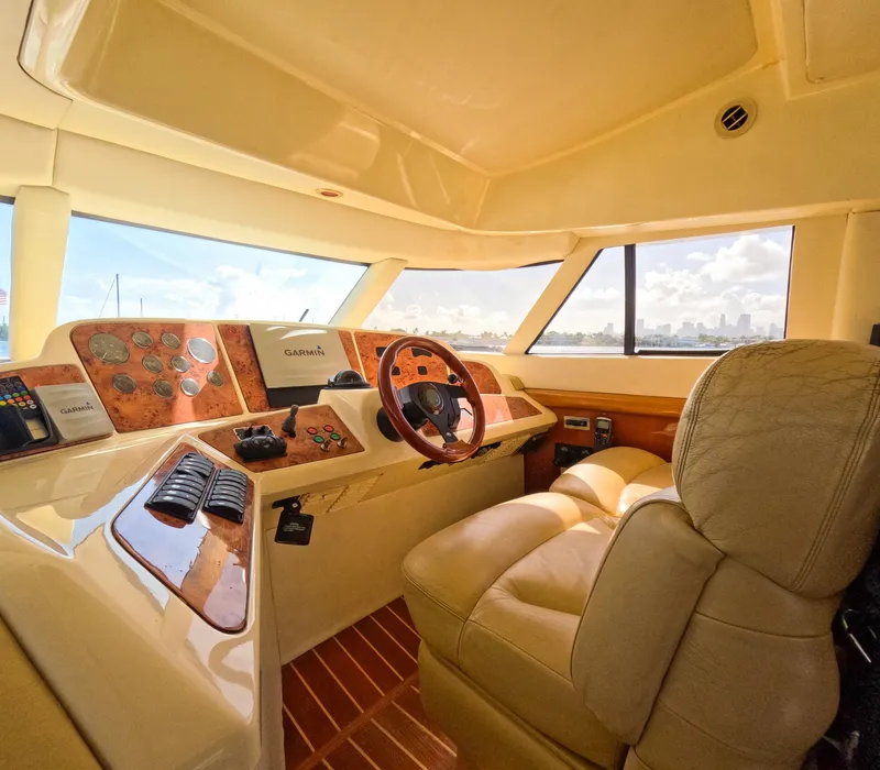 Slide: The Image of Luxurious 2004 Sealine 47 yacht interior with leather seating and modern dashboard controls. - 19