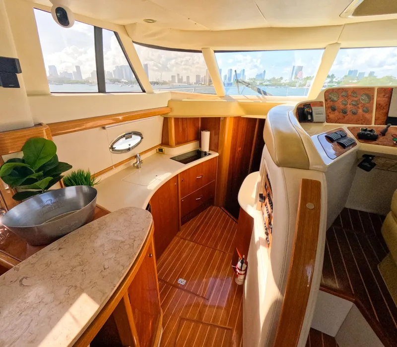 Slide: The Image of Luxurious 2004 Sealine 47 yacht interior with wood finish and panoramic windows. - 21