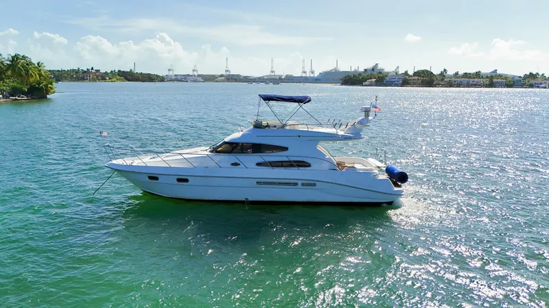 Slide: The Image of 2004 Sealine 47 yacht cruising on a sunny, scenic waterway. - 3