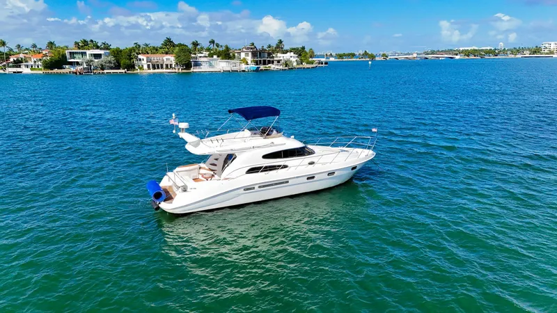 Slide: The Image of 2004 Sealine 47 yacht cruising on clear blue waters under a sunny sky. - 4