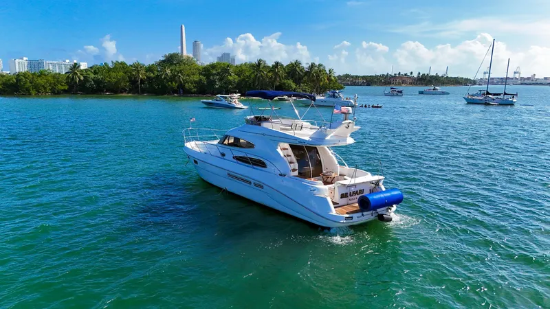 Slide: The Image of 2004 Sealine 47 yacht cruising on a sunny, tropical waterway with lush greenery. - 6
